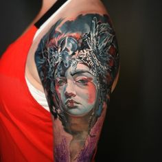 a woman's half sleeve tattoo with an image of a woman wearing a headdress