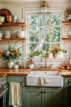 a kitchen filled with lots of green cabinets and wooden counter tops next to a window