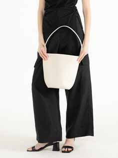 Editor's Notes object museum is a brand that develops anti-abstract and physical designs.- Textured cow leather used bucket bag- Multiple-way wearable bag- Spacious and practical design- Engraved brand logo on the front Measurements(in.)- Size: 6.69 in. / 13.19 in. * 10.63 in. * 6.30 in.- Strap: 9.45 in. Composition & Care- Cow Skin- Leather may have fine scratches and wrinkles- Bright leather can get stained by denim or dark outfits- Avoid direct heat and moisture- Wipe off m White Bucket Bag With Leather Handles, Modern Cream Bucket Bag For Everyday, Modern Everyday Bucket Bag, Minimalist Bucket Bag For Everyday Use, Minimalist Bucket Bag For Everyday, Bucket Shoulder Bag With Dust Bag For Work, Minimalist Everyday Bucket Bag, Versatile White Leather Bucket Bag, Leather Handle Bucket Bag For Work