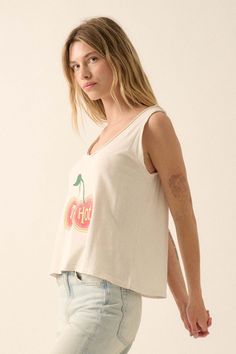 Mineral washed graphic tank top. Vintage-style cherries graphic print with "Too Hot" text. Scoop neckline with raw edge. Sleeveless with raw-edge arm holes. Scoop back. Relaxed fit. 100% Cotton. Imported top designed and printed in LA. Model wears size S. White Relaxed Fit Tank Top With Graphic Print, Relaxed Fit Cotton Graphic Tank Top, Y2k Cotton Graphic Print Tank Top, Cotton Screen Print Racerback Tank Top, 90s Graphic Print Cotton Tank Top, Raw Edge, Graphic Tank, White Tank Top, Scoop Neckline