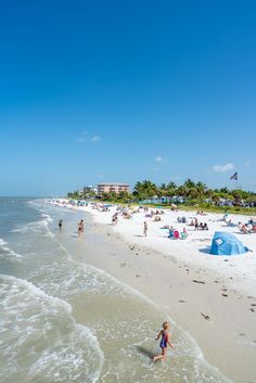 the beach is crowded with people and umbrellas