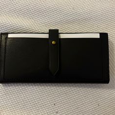 Brand New, Never Used Wallet With Protective Wrapping Black Travel Wallets With Snap Closure, Black Travel Wallet With Snap Closure, Black Bifold Clutch With Card Slots, Black Bifold Wallet For Everyday Use, Classic Black Wallet For Everyday Use, Classic Black Wallets For Everyday, Black Wallet With Snap Closure, Chic Leather Card Holder For Everyday, Bifold Wallet With Magnetic Closure For Daily Use