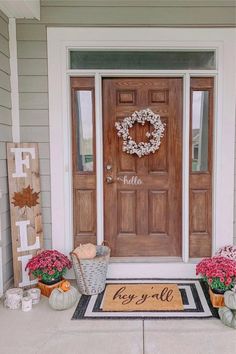 the front door is decorated with flowers and wreaths