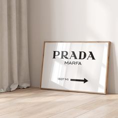 there is a sign that says prada marfa next to a window with curtains