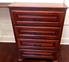 a wooden dresser sitting on top of a hard wood floor