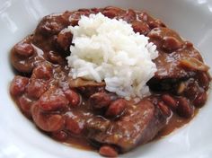 a white bowl filled with beans and rice