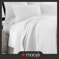 an image of a bed with white sheets and pillows on top of the coverlet