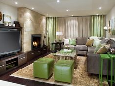 a living room filled with furniture and a flat screen tv mounted on a wall next to a fire place