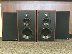 two bookshelf speakers sitting next to each other