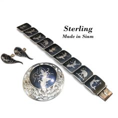 *Description: This is a sterling silver bracelet, brooch, and screwback earrings with black enamel from the 1930s.  Siam's name was officially changed to Thailand in 1939.  These pieces have never been worn but have natural patina on the silver. This would be a great addition to your vintage jewelry collection or make a great vintage gift! *Reference: Brief history of the designs: It is technically Niello or Nielloware, created by carving out areas of the silver, and baking a sulfur/metals powde Classic Engraved Enamel Jewelry, Art Deco Hallmarked Enamel Jewelry, Classic Silver Jewelry With Enamel, Silver Enamel Jewelry For Evening, Traditional Collectible Jewelry Brooch, Hallmarked Sterling Silver Jewelry For Evening, Classic Sterling Silver Jewelry With Black Enamel, Sterling Silver Hallmarked Jewelry For Evening, Hallmarked Sterling Silver Evening Jewelry