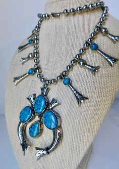 "Mid Century Silver tone Metal Squash Blossom Necklace/Earrings Set with Simulated Turquoise. Ca 1950. Necklace signed Art . Earrings marked with pat No and they are Screwed/Clips. The necklace it is 24\" L. It has 8 Squash blossoms. 4 at each side. 4 are 1- 1/2\" H and 4 are 1- 1/4\" L. The Naja it is 3\"H x 2\"L Each earring it is 1-3/4\" H x 5/8\". No damage. Great condition." Western Style Turquoise Dangle Jewelry, Collectible Teardrop Turquoise Jewelry, Nickel-free Turquoise Western Jewelry, Blue Teardrop Western Style Jewelry, Western Style Nickel Free Turquoise Jewelry, Western Teardrop Jewelry Gift, Nickel Free Blue Southwestern Jewelry, Southwestern Nickel-free Turquoise Jewelry, Southwestern Turquoise Nickel-free Jewelry