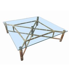 a glass and bamboo coffee table with metal legs on an isolated white background for display