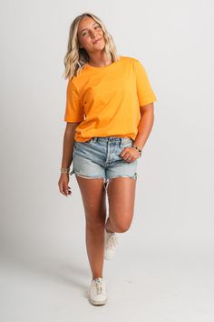 Basic short sleeve t-shirt from Lush Fashion Lounge women's boutique in Oklahoma City. Lush boutique in OKC has a variety of cute basic tops and more! This trendy basic t-shirt is a must have! Pair this basic orange top with shorts and sneakers for a cute and casual look! Model is 5'4 size 26 wearing size small. 100% cotton Top With Shorts, Basic Shorts, Orange Top, Women's Boutique, Basic T Shirt, Basic Tops, Oklahoma City, Ladies Boutique, Short Sleeve Top