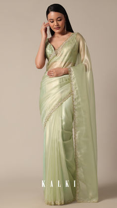 "Step into sophistication with this Graceful Green Tissue Saree. It is featuring meticulous bead and cutdana work on a scalloped border. The light green and glass tissue accents enhance the overall appeal, creating a perfect choice for your party wear collection. Meticulous detailing and the inclusion of unstitched blouse fabric ensure a customized fit.
" Pista Colour Saree, Pista Green Saree, Green Tissue Saree, Pista Green Pre-draped Saree With Sheer Dupatta For Party, Tissue Sarees, Pastel Colour Saree, Light Green Saree Look