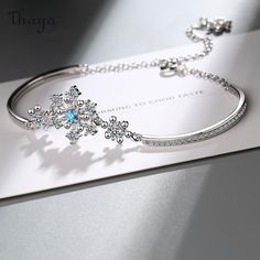 Crafted with delicate silver and shimmering crystals, our Fresh Snowflake Bracelet symbolizes purity and uniqueness. Each snowflake represents the beauty of individuality and the transformative power of winter. Embrace the enchanting story of snow as you wear this timeless piece, a reminder to cherish your own distinctive journey.   - Brand: Thaya  - Material: Environmentally friendly copper plated real gold  - Size: Bracelet length 16cm+5cm extension chain  - Shape: Snowflake  - Gender: Women's Wedding Gift For Friend, Snowflake Bracelet, Wedding Bride Jewelry, Wholesale Gifts, Friends Mom, Copper Bracelet, Crystal Wedding, Bracelets For Women, Bride Jewellery