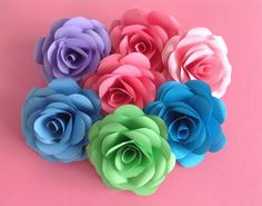 multicolored paper flowers on pink background