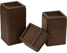 three brown trash cans sitting next to each other