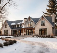 a large house with lots of windows and snow on the ground