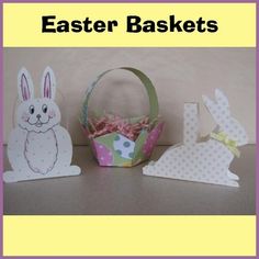 three paper easter baskets with bunny ears on them