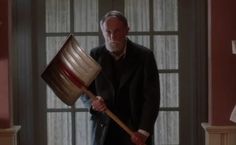 an older man holding a large metal bucket