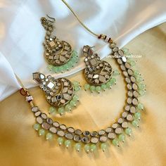 Mint Simple Mirror Necklace set with maangtikka. This elegant Mint Simple Mirror Necklace set with maangtikka adds a touch of sophistication to any outfit. With its delicate mirror detailing and intricate design, this jewelry set is perfect for any formal occasion. The inclusion of the maangtikka also adds a traditional and cultural aspect to the overall look. Elevate your style with this beautiful and versatile set. Festive Kundan Necklace With Mirror Work For Puja, Kundan Necklace With Mirror Work For Diwali Puja, Bollywood Style Kundan Necklace With Mirror Work For Puja, Bollywood Jewelry With Mirror Work For Puja, Bollywood Style Jewelry With Mirror Work For Puja, Festive Mirror Work Jewelry For Puja, Temple Jewelry With Mirror Work For Puja, Chandbali Jewelry With Mirror Work For Puja, Chandbali Mirror Work Jewelry For Puja