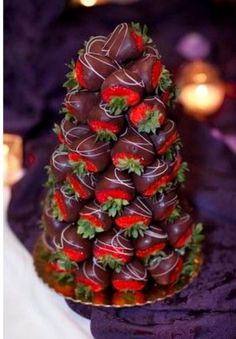 chocolate covered strawberries stacked on top of each other in the shape of a christmas tree