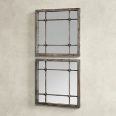 two mirrors hanging on the wall next to each other, one is made out of wood