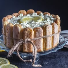 a cake with lemons and whipped cream on top