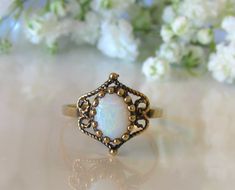 a white opal ring sitting on top of a table