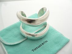 Overview:Offered for sale is a wonderful, super cool, and gorgeous Tiffany & Co Silver Peretti Double Open Cuff / Bracelet. Definitely a Tiffany piece that you will get your money's value for. It works perfectly with pretty much any attire your put on, AND is the perfect Tiffany statement piece. It is the perfect piece that fits a lifestyle on the go -- the cuff can be worn to pretty much any occasion! It is simple, elegant, and classic all rolled into one bracelet - it looks awesome worn al Luxury Wide Band Cuff Bracelet As Gift, Luxury Wide Band Cuff Bracelet Gift, Designer Cuff Bracelet For Anniversary, Designer Polished Cuff Bracelet As Gift, Designer Polished Finish Cuff Bracelet As Gift, Designer Polished Cuff Bracelet Gift, Luxury Wide Band Bangle As Gift, Luxury Open Cuff Bracelet As Gift, Designer Cuff Jewelry For Anniversary