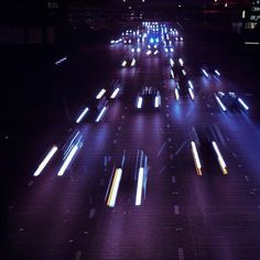 cars driving down a highway at night time