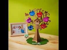 the family tree is next to a photo frame and an ornament on a table