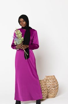 Invitation Accepted! The Fuschia Satin Long Sleeve Maxi Dress features a round neckline, buttons on the cuff, batwing sleeves, pleats on the chest, and sheath silhouette. The dress is fully lined. This soft and feminine texture and color gives the perfect level of modesty and elegance! Match it with one of our Hijab for the perfect look! Zip fastening Regular fit True to size Satin Lined Model is 5'10" wearing a size Small Elegant Crew Neck Dress For Daywear, Elegant Crew Neck Daywear Dress, Feminine Texture, Satin Long Sleeve, Sleeve Maxi Dress, Long Sleeve Maxi, Maxi Wrap Dress, Off Black, Batwing Sleeve