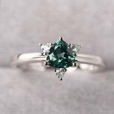 ◆ The ring is handcrafted from sterling silver and decorated with a dazzling 6*6 mm green sapphire and CZs. It is suitable for engagement/anniversary/daily occasion. ◆ Production Description: Main stone Type: Lab Green Sapphire Main Stone Shape: Trillion Cut Main Stone Size: 6*6 mm(0.96ct) Side stone: CZ Metal: 925 Sterling silver - Other options available in the drop down menu ◆ Customization: √Free for Add Engraving √Other Metal Type Available √Other Gemstones & Shapes Available √Personali Green Diamond Heart Cut Ring, Elegant Green Sapphire Promise Ring, Green Diamond Ring With Princess Cut And Accent Stones, Heart Cut Green Emerald Ring For Formal Occasions, Green Heart Cut Emerald Ring For Formal Occasions, Green Princess Cut Diamond Ring With Accent Stones, Formal Green Heart Cut Emerald Ring, Silver Sapphire Ring With Accent Stones For May Birthstone, Green Diamond Birthstone Ring With Accent Stones