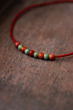 This unique choker necklace was made of red-pink, orange, green, red ceramic beads, red cowhide leather cord with copper end clasps, copper lobster claw and chain. Perfect for everyday wear! The length of necklace is about 43.5cm or 17.1 inches and 3 cm of adjustable length chain. Other necklaces you can find in my store in the necklace section. https://www.etsy.com/shop/NaTavelli?section_id=14843046&ref=shopsection_leftnav_5 Thanks for a visit. Casual Wooden Beads Jewelry As Gift, Casual Wooden Beaded Jewelry Gift, Bohemian Jewelry With Tiny Round Beads, Bohemian Round Beads For Gifts, Minimalist Wooden Beads Jewelry Gift, Bohemian Beaded Necklaces With Tiny Beads, Bohemian Beaded Necklaces With Spacer Beads, Bohemian Beaded Necklace With Tiny Beads, Bohemian Round Beaded Necklace With Tiny Beads