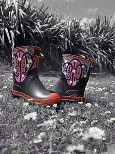 a pair of boots with the word monogrammed on them sitting in some grass