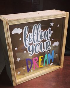 a wooden frame with the words follow your dream painted on it and stars in the sky