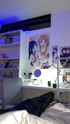 a room with a bed, desk and shelves filled with anime art on the wall