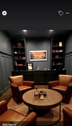 a living room filled with brown leather chairs