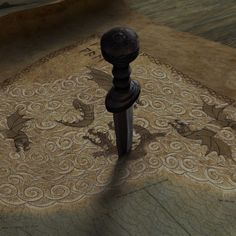 an artistic carpet with dragon designs on it and a wooden post in the middle,