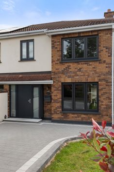 a brick house with black doors and windows