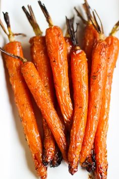 some carrots are sitting on a white plate and ready to be eaten by someone