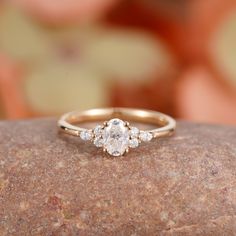 a diamond ring sitting on top of a rock