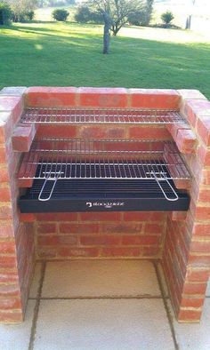 an outdoor brick oven with the door open and grilling racks on it's sides