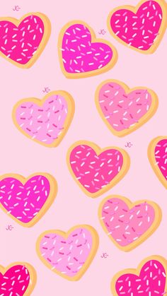 donuts in the shape of hearts on a pink background