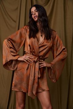 A Tribe classic: The Gold Standard. Our original wrap dress will be flattering at any height. Perfect for vacation or a dinner by the beach as a wrap dress, or leave open to wear as a kimono. A true versatile must have for your closet! SIZE RECOMMENDATIONS & MATERIALS: - rust kimono dress  - v-neck - fabric belt in