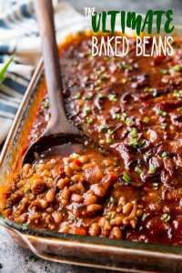 baked beans in a casserole dish with a spoon on the side and text overlay that reads ultimate baked beans