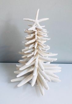 a white christmas tree made out of shells