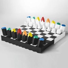 a black and white chess board with colored pieces on it