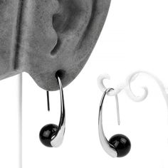 Gauge: 18g and #124; Color: Silver and #124; (pair). Sold as a pair. Enhance your look with these Sterling Silver Black Orb Hook Earrings. Crafted from quality material and featuring a black synthetic stone orb, they're a sophisticated addition for anyone with a basic ear piercing. This stylish accessory is a must-have for your everyday wear.All measurements are approximate: The entire ear hook measures 33mm tall by 10mm wide. Made from sterling silver. More earrings are available here. Material Modern Black Round Hoop Earrings, Modern Black Sterling Silver Earrings, Modern Black Hypoallergenic Hoop Earrings, Modern Silver Earrings With Black Enamel, Modern Black Jewelry With Ear Wire, Modern Black Drop Plug Earrings, Modern Onyx Earrings With Black Enamel, Black Teardrop Modern Jewelry, Modern Onyx Drop Earrings